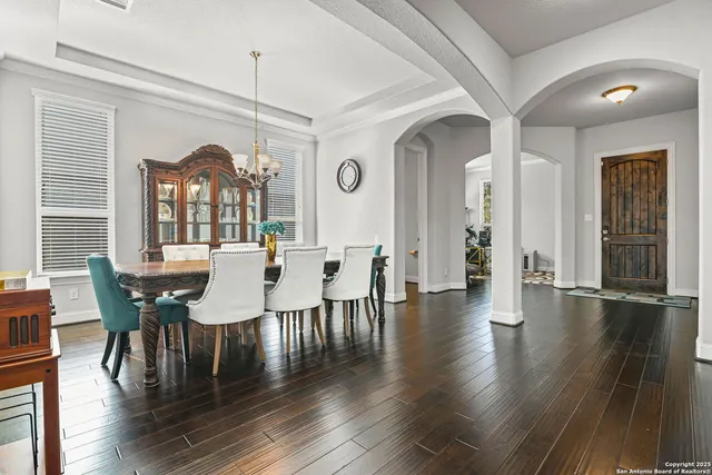 a view of a dining room with furniture and wooden floor