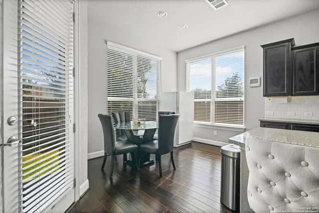 a view of a dining room with furniture and wooden floor