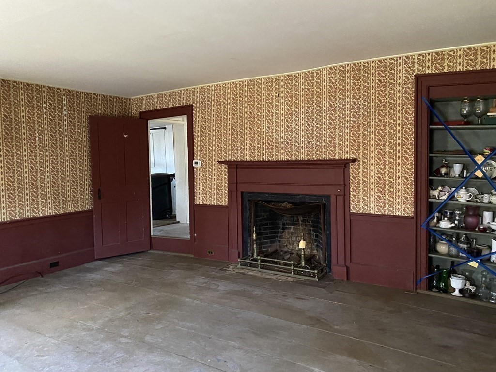 85 Main Street Groveland, MA 01834 - Photo 13 of 18 a view of an empty room with window and fireplace