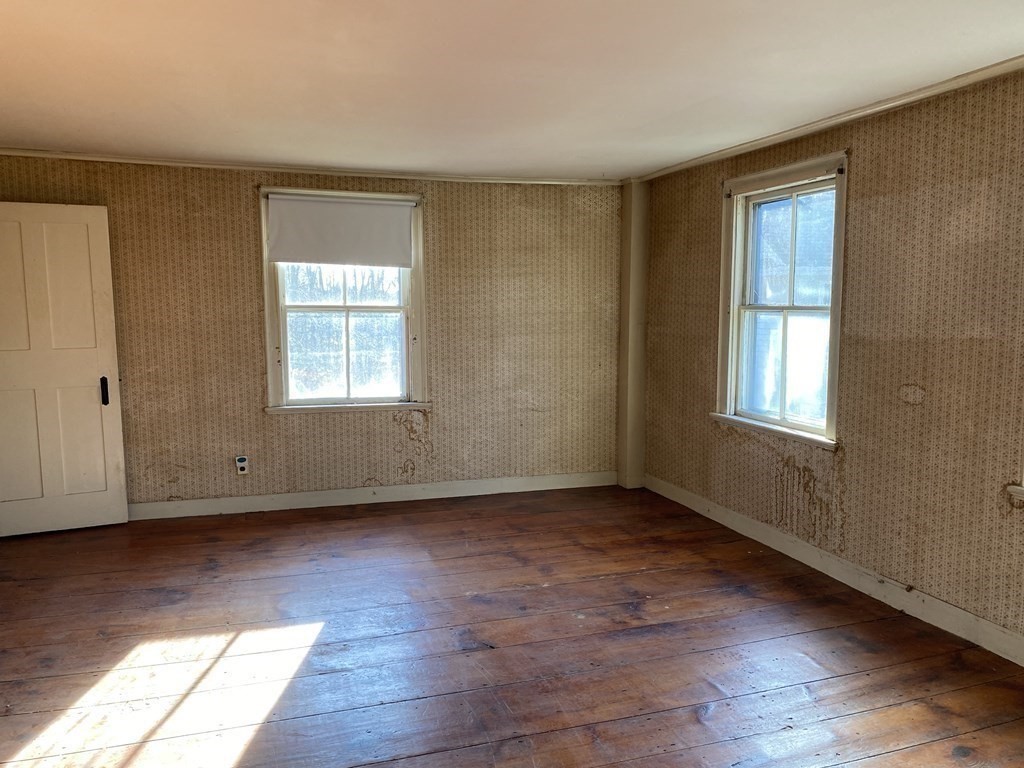 85 Main Street Groveland, MA 01834 - Photo 14 of 18 a view of an empty room with wooden floor and a window