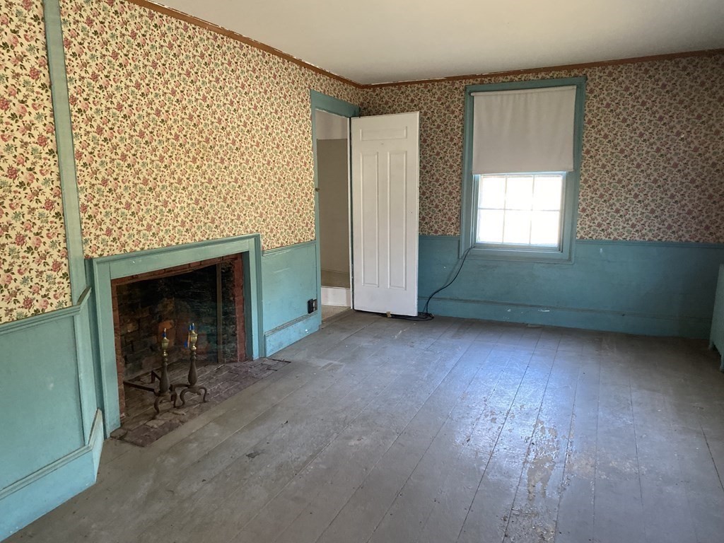 85 Main Street Groveland, MA 01834 - Photo 16 of 18 an empty room with a fireplace and window