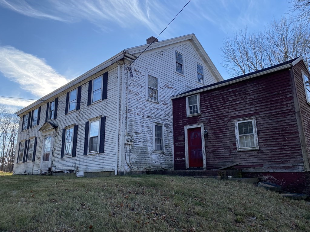 85 Main Street Groveland, MA 01834 - Photo 5 of 18 a brick house that has a small yard and large trees