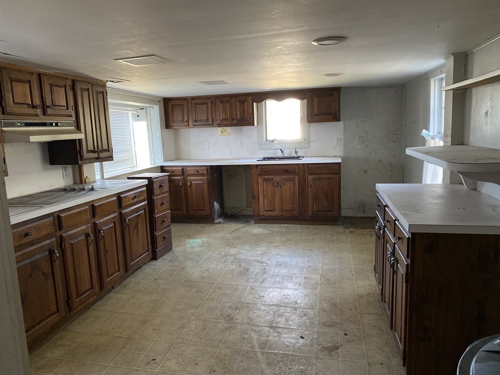 85 Main Street Groveland, MA 01834 - Photo 7 of 18 a kitchen with stainless steel appliances granite countertop a sink counter space cabinets and a counter top space