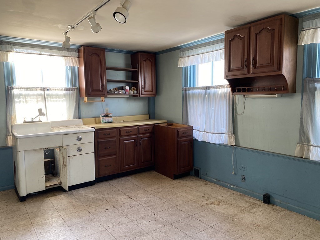 85 Main Street Groveland, MA 01834 - Photo 8 of 18 a kitchen with a stove microwave and sink