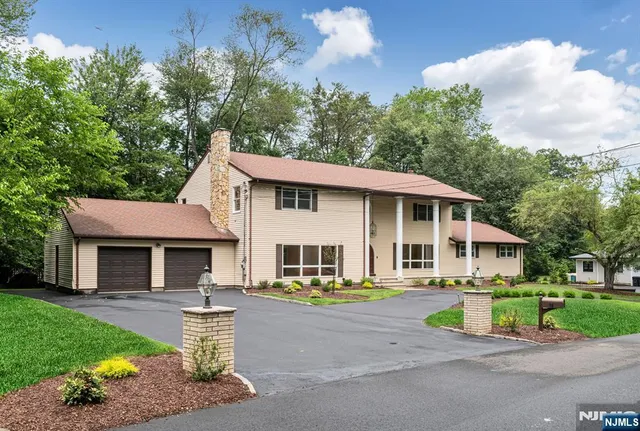 a front view of a house with a yard table and chairs