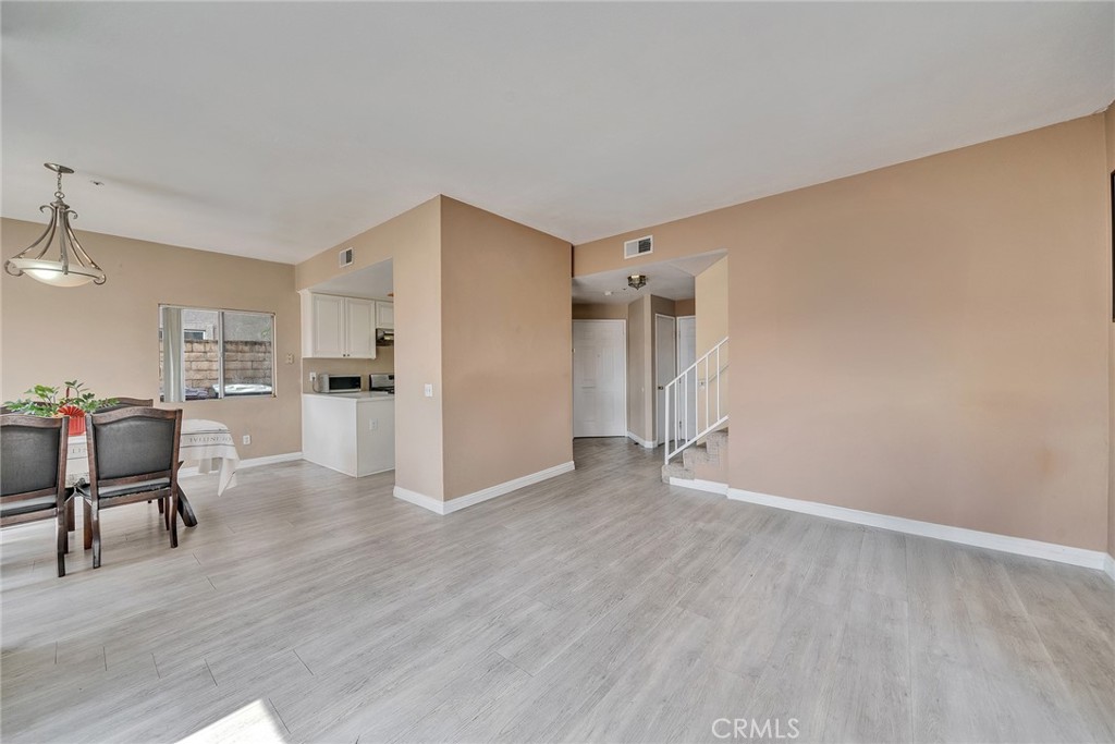 11320 Iris Lane El Monte, CA 91731 - Photo 3 of 14 a view of a kitchen with wooden floor and a refrigerator