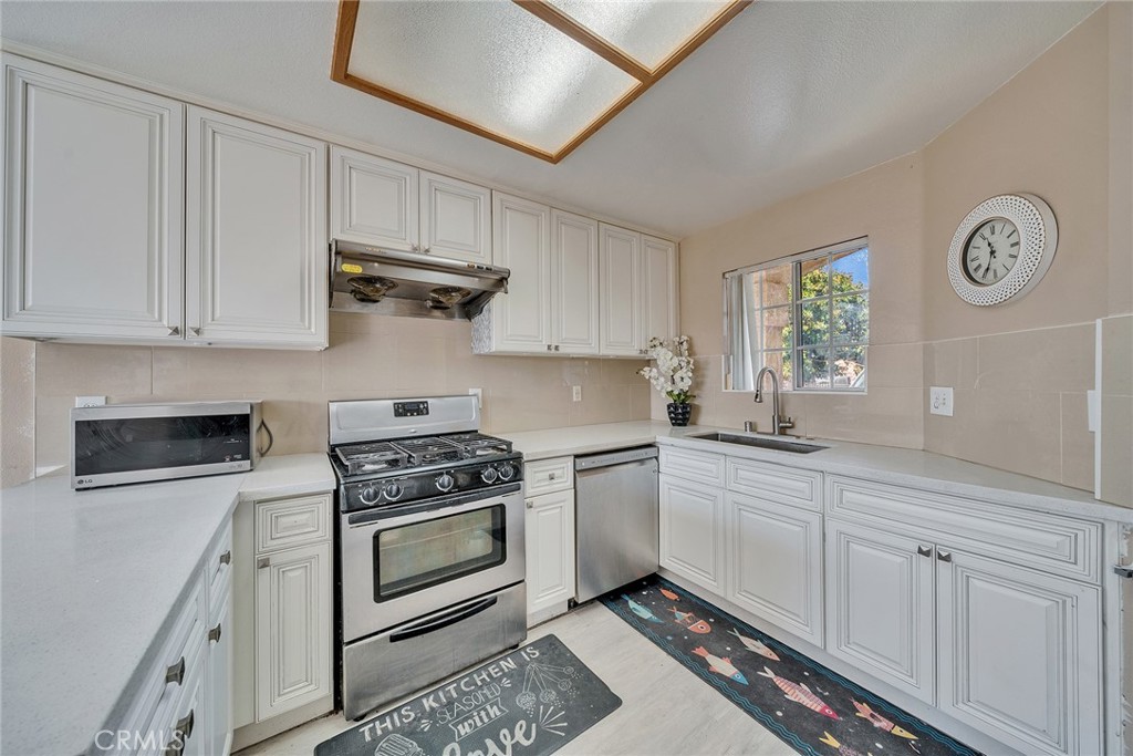 11320 Iris Lane El Monte, CA 91731 - Photo 6 of 14 a kitchen with cabinets and steel stainless steel appliances
