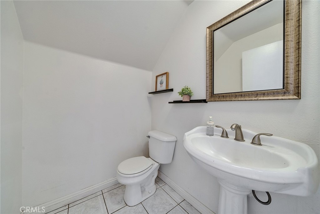 11320 Iris Lane El Monte, CA 91731 - Photo 8 of 14 a bathroom with a toilet a sink and mirror