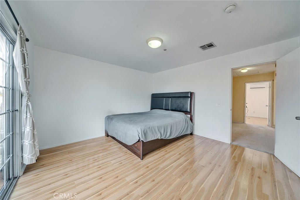 11320 Iris Lane El Monte, CA 91731 - Photo 9 of 14 a bedroom with a bed and wooden floor