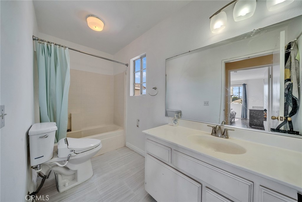11320 Iris Lane El Monte, CA 91731 - Photo 10 of 14 a bathroom with a sink a toilet and a mirror