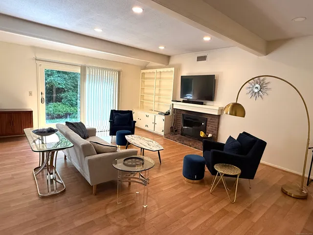 a living room with furniture fireplace and a flat screen tv
