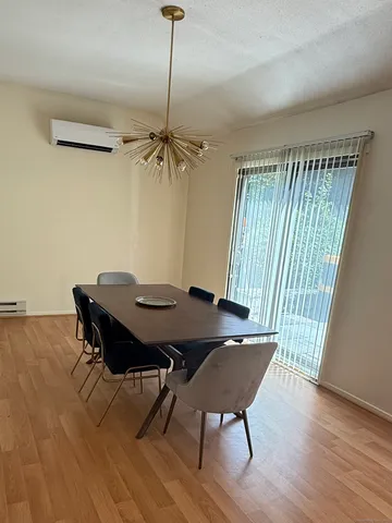 a view of a dining room with furniture window and wooden floor