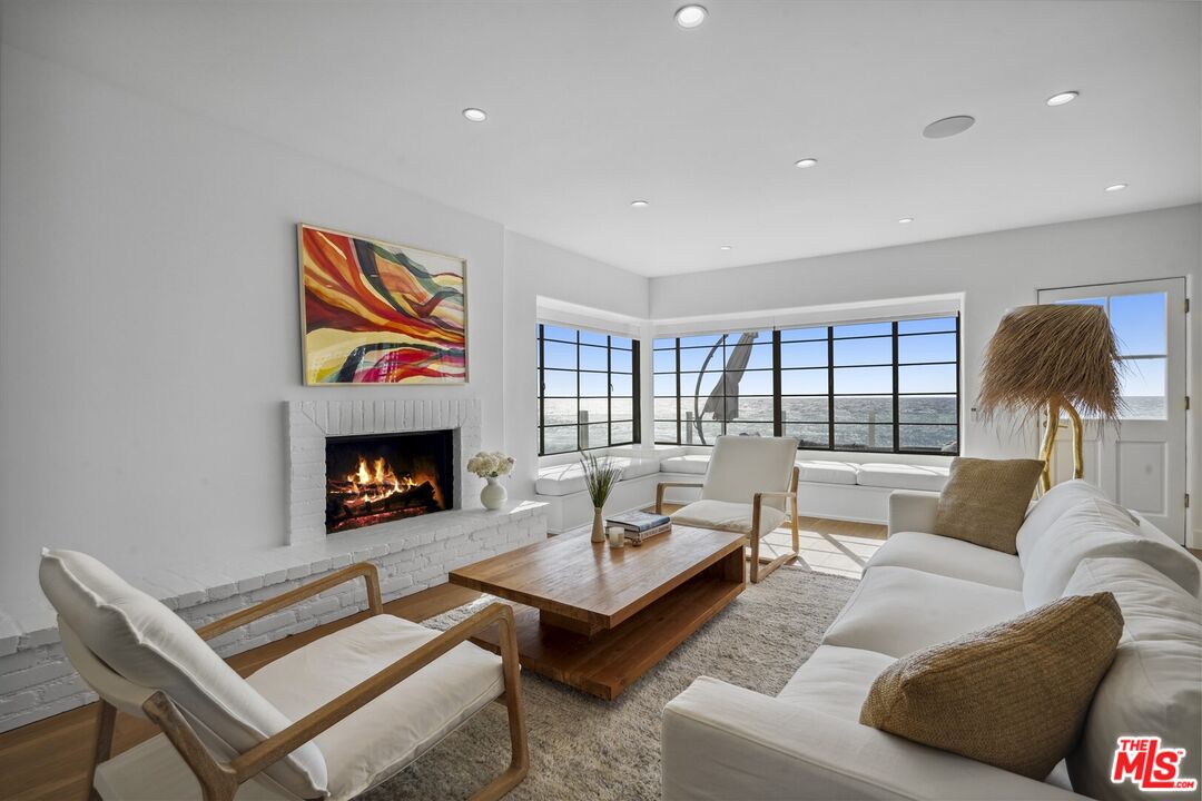 31500 Victoria Point Road Malibu, CA 90265 - Photo 2 of 53 a living room with furniture and a fireplace
