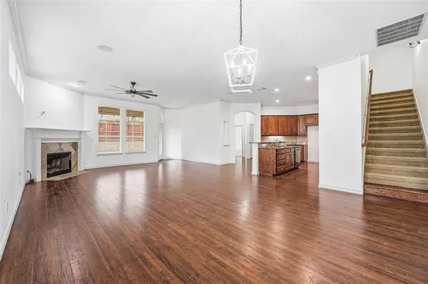 a view of empty room with wooden floor and fireplace