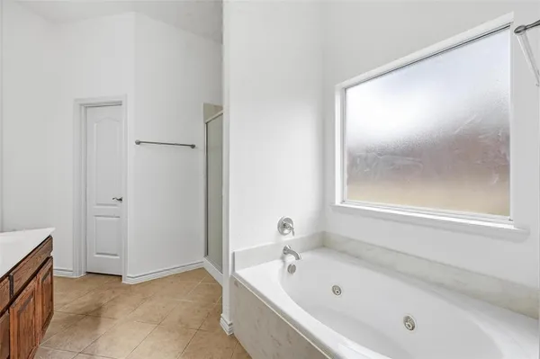 a bathroom with a bathtub and a shower