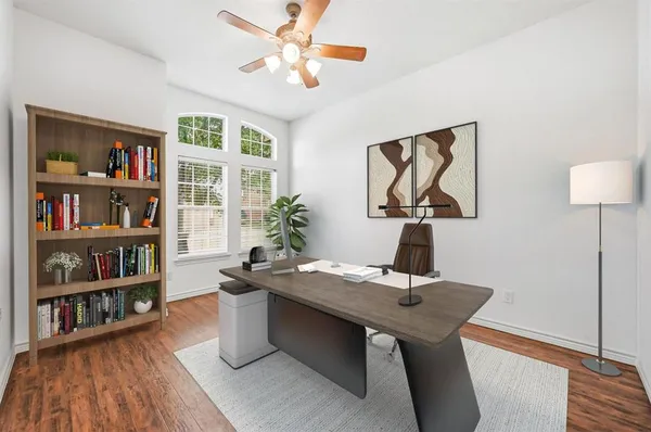 a view of a workspace with furniture and wooden floor