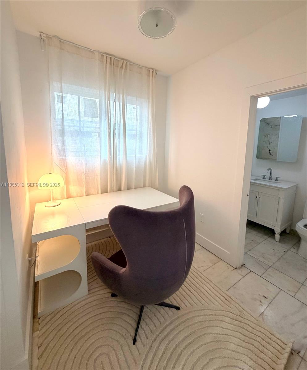 801 8th Street, Unit 202 Miami Beach, FL 33139 - Photo 6 of 9 a living room with a couch and a table