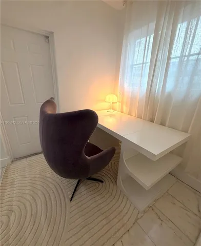 a workspace with furniture and window