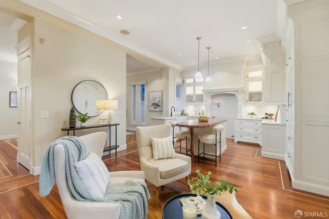 a living room with fireplace furniture dining table and a fireplace