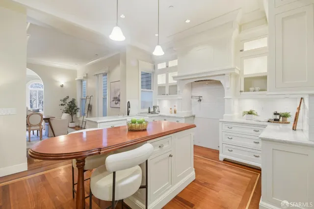 a kitchen with a sink cabinets and living room view