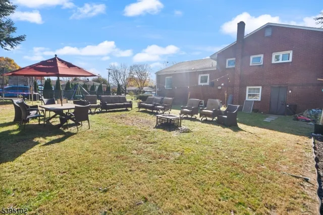 a swimming pool with outdoor seating yard and barbeque oven