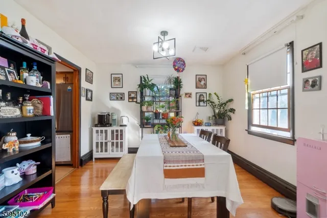 a living room with furniture a flat screen tv and a book shelf