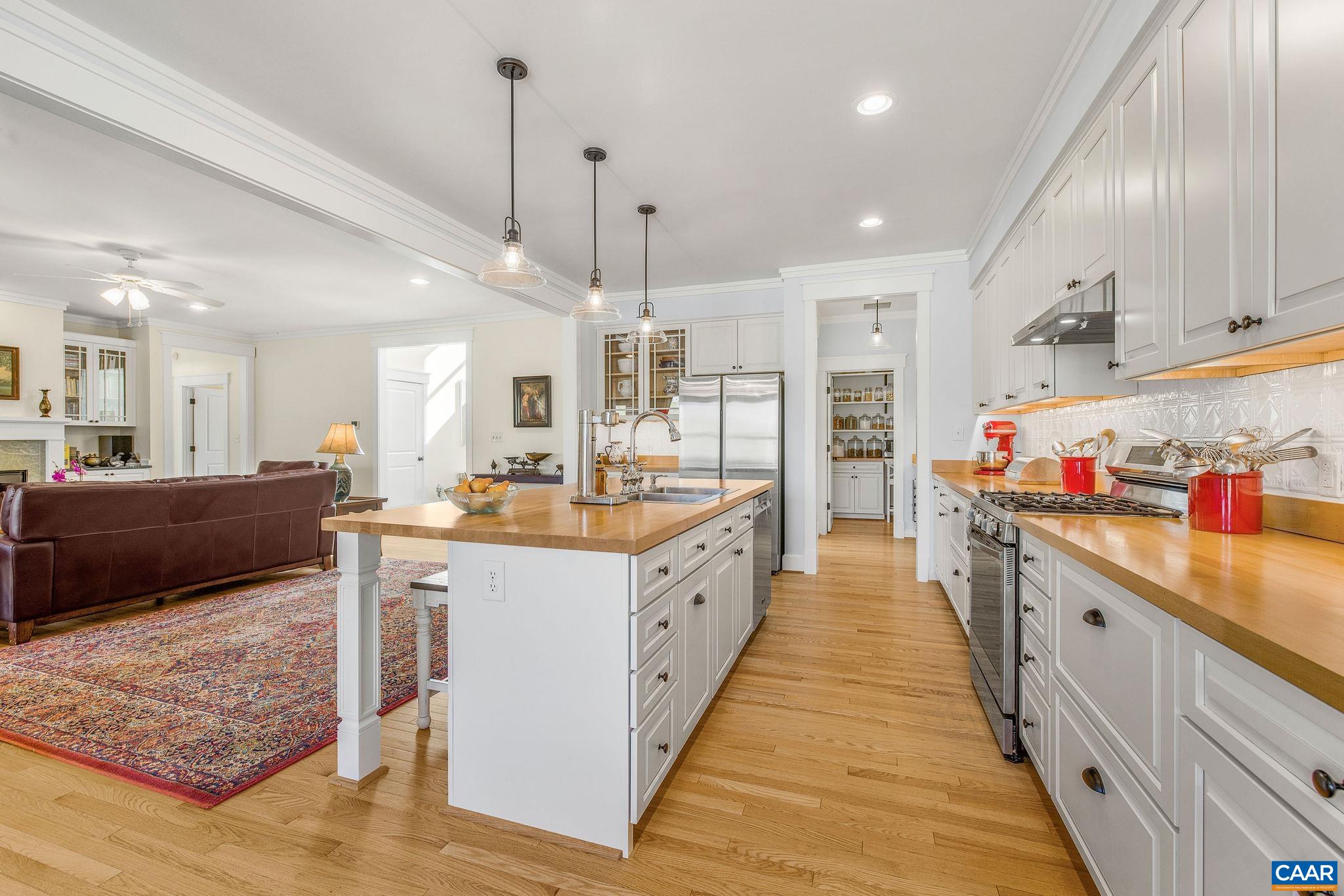 4764 Advance Mills Road Earlysville, VA 22936 - Photo 35 of 72 a large kitchen with kitchen island a sink stove and wooden floor