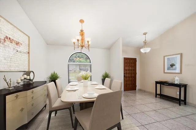 a view of a dining room with furniture and a chandelier