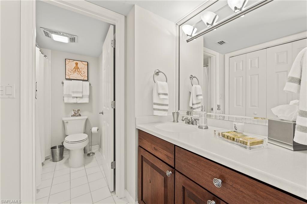 4155 Crayton Road, Unit 107 Naples, FL 34103 - Photo 28 of 36 Bathroom with vanity, tile patterned flooring, and toilet