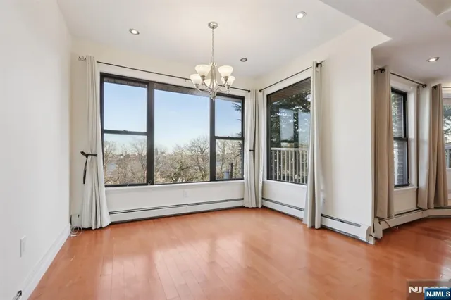 an empty room with floor to ceiling windows and outdoor view