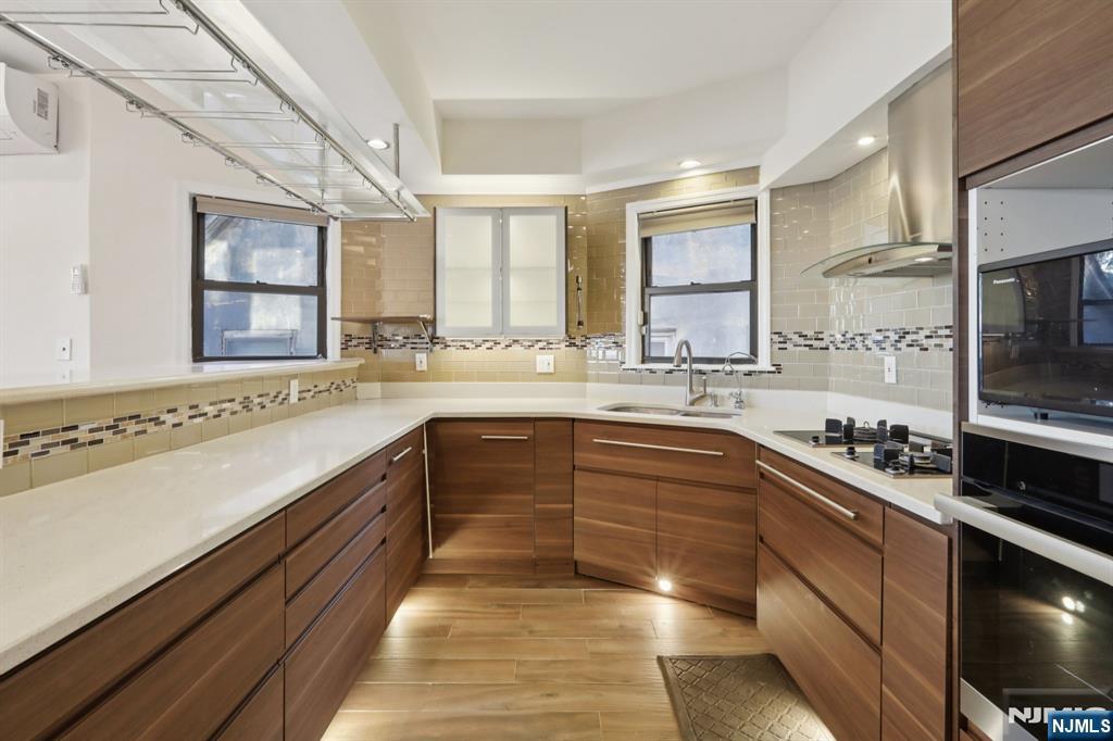 32 Hudson Terrace, Unit 2 Edgewater, NJ 07020 - Photo 13 of 42 a large kitchen with a large window and stainless steel appliances