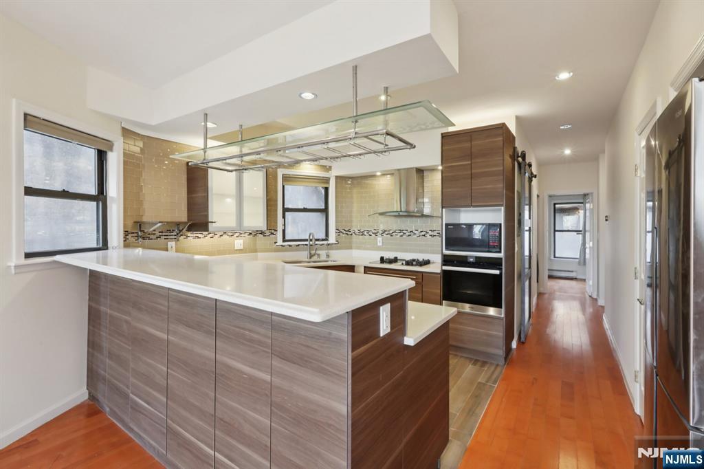 32 Hudson Terrace, Unit 2 Edgewater, NJ 07020 - Photo 14 of 42 a large white kitchen with a large window