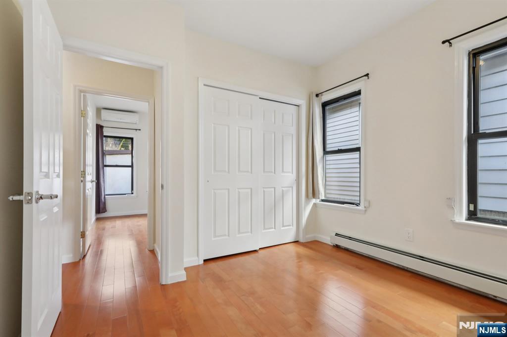 32 Hudson Terrace, Unit 2 Edgewater, NJ 07020 - Photo 20 of 42 wooden floor in an empty room with a window