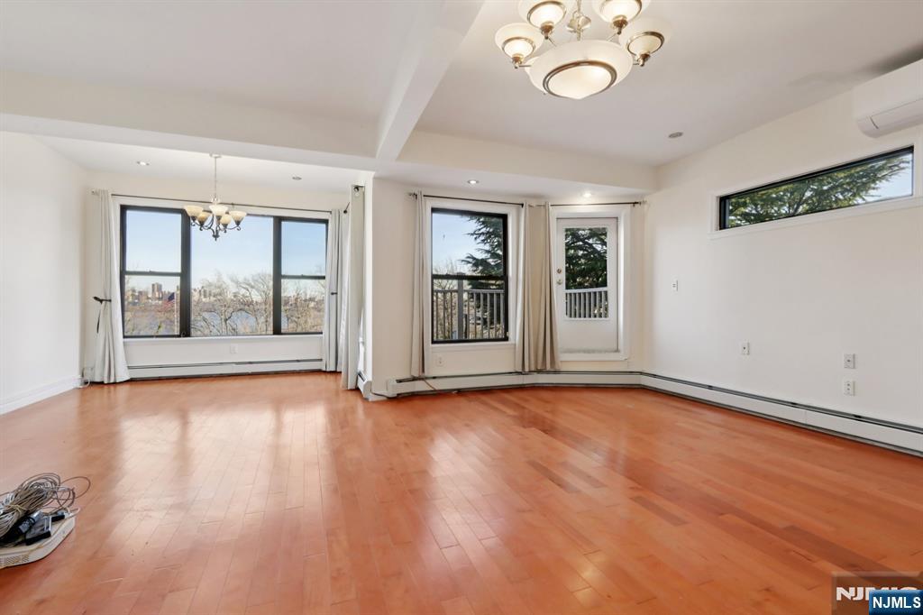 32 Hudson Terrace, Unit 2 Edgewater, NJ 07020 - Photo 3 of 42 an empty room with wooden floor and window