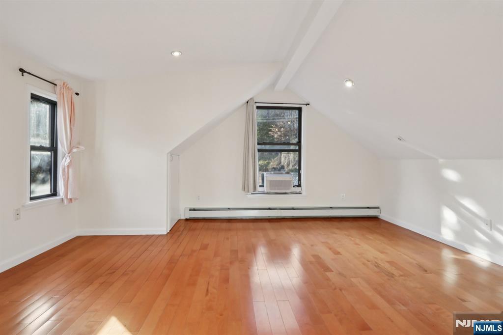 32 Hudson Terrace, Unit 2 Edgewater, NJ 07020 - Photo 33 of 42 a view of an empty room with a window and wooden floor