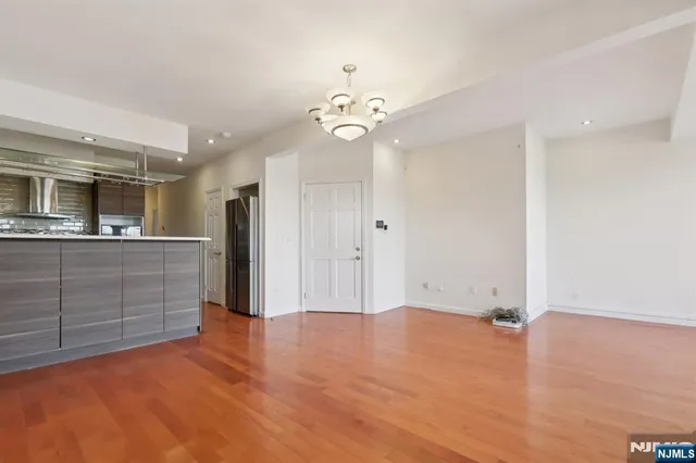 a view of a kitchen with a dishwasher cabinets and wooden floor