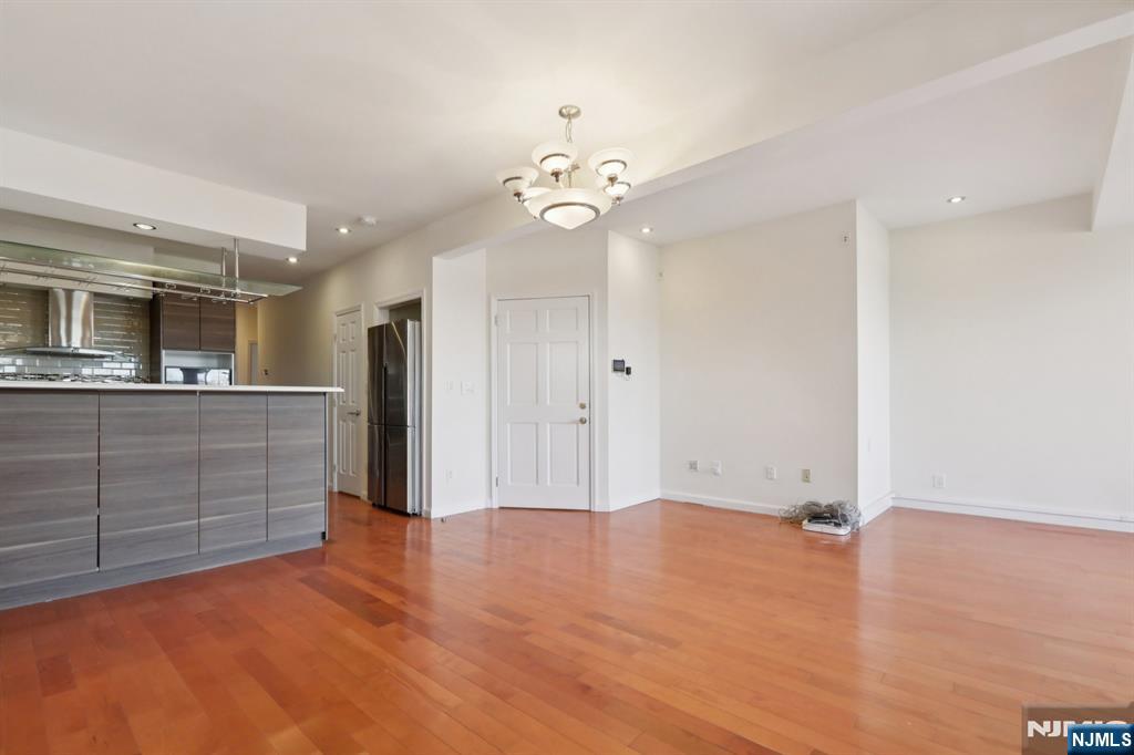 32 Hudson Terrace, Unit 2 Edgewater, NJ 07020 - Photo 9 of 42 a view of a kitchen with a dishwasher cabinets and wooden floor