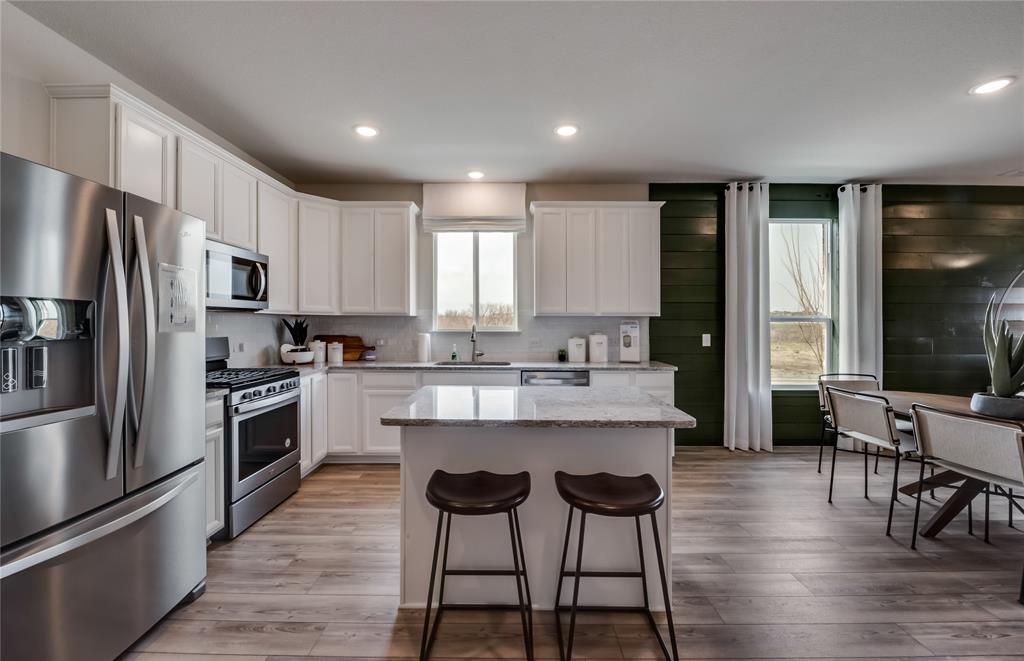14053 Ladbroke Street Pilot Point, TX 76258 - Photo 4 of 19 Spacious kitchen with eat-in bartop island