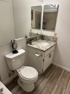 2905 Niagara, Unit 171 Turlock, CA 95382 - Photo 8 of 10 a bathroom with a granite countertop toilet sink and mirror