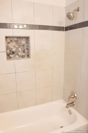 a bathroom with a shower and a sink