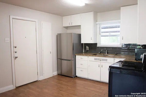 a kitchen with a refrigerator stove and sink