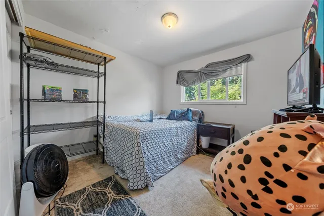 a bedroom with bed and a window