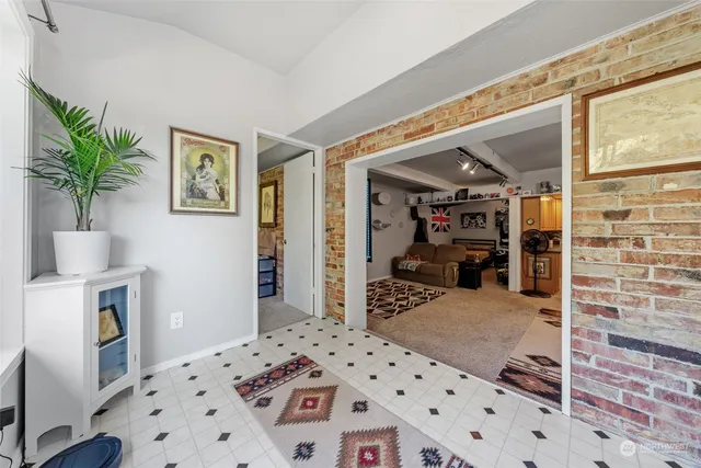a bedroom with furniture and a flat screen tv