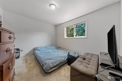a bedroom with furniture and a flat screen tv