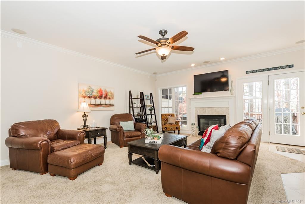 11161 Watertrace Drive Tega Cay, SC 29708 - Photo 2 of 24 a living room with furniture a fireplace and a flat screen tv