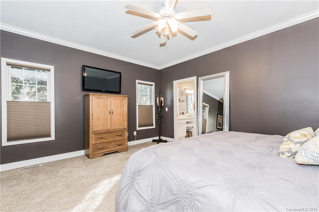 11161 Watertrace Drive Tega Cay, SC 29708 - Photo 11 of 24 a large white bed in a spacious bedroom and a window