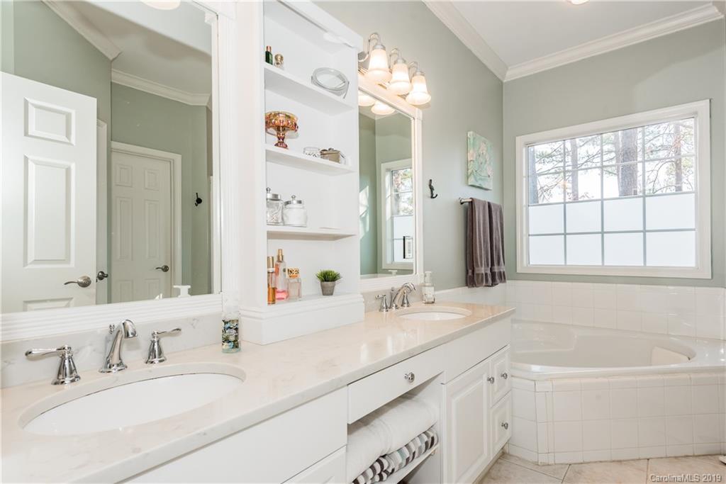 11161 Watertrace Drive Tega Cay, SC 29708 - Photo 12 of 24 a bathroom with a tub a sink double vanity and a mirror