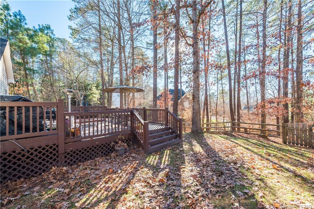11161 Watertrace Drive Tega Cay, SC 29708 - Photo 23 of 24 a view of a wooden deck with a large trees