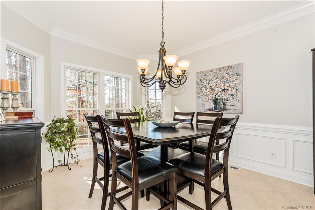 11161 Watertrace Drive Tega Cay, SC 29708 - Photo 4 of 24 a view of a dining room with furniture and a chandelier