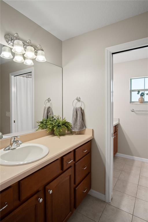 9045 Lake Hatchineha Road Kissimmee, FL 34759 - Photo 32 of 47 a bathroom with a sink and a mirror